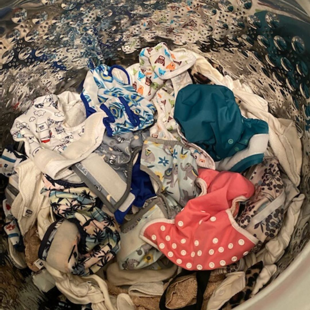 washing machine full of cloth diapers