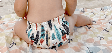 image of a baby wearing a thirsties reusable swim diaper in cowabunga