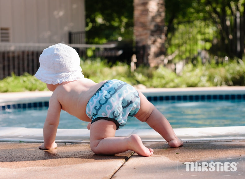 -image of baby in swim diaper beside pool