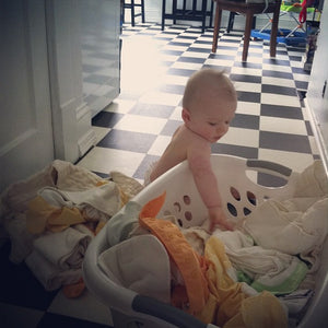 image of baby with folded laundry