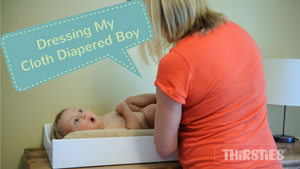 image of woman changing diaper on baby