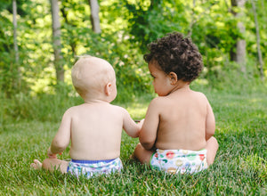 image of two children sitting in a field