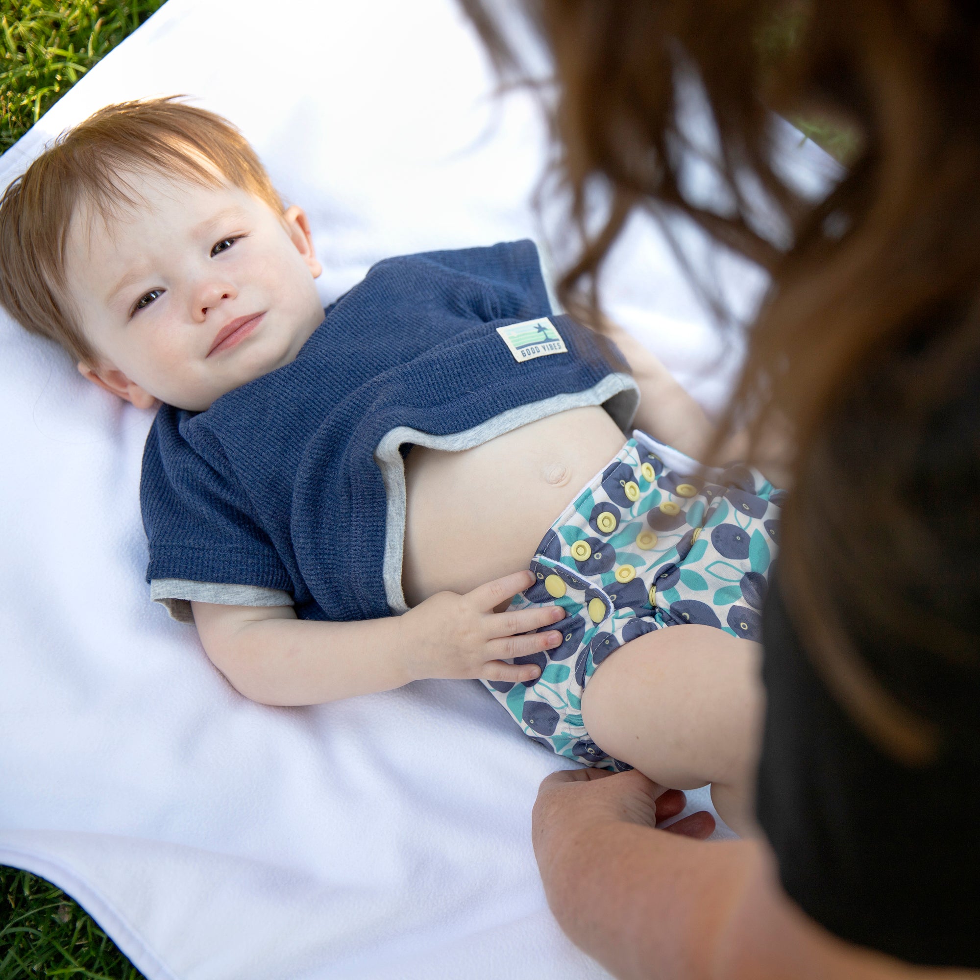 Image of baby wearing a Thirsties all in one in blueberry
