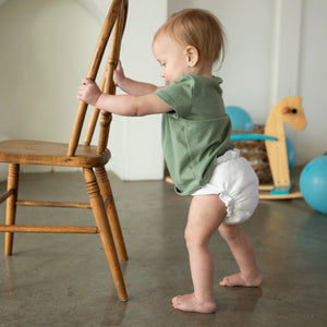 -Image of a baby showing off her Thirsties Duo Fitted Diaper