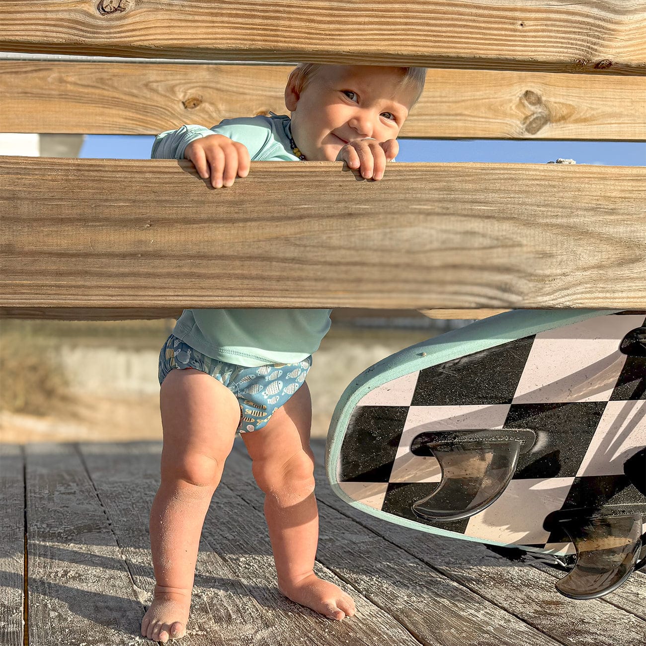 Image of baby wearing a Thirsties Swim Diaper in Schooling