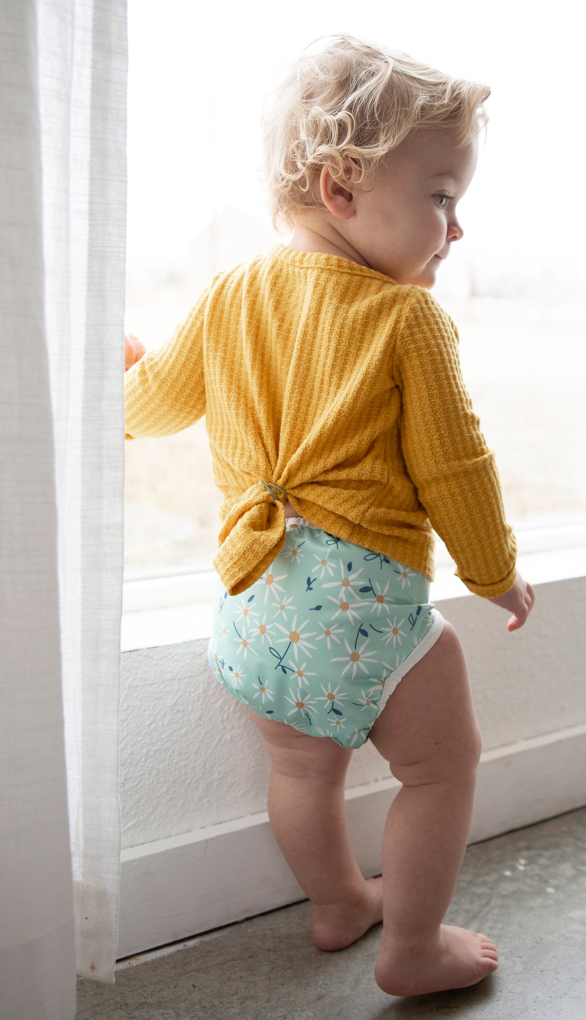 Image of baby wearing a Thirsties Cloth Diaper in Woodland Aster