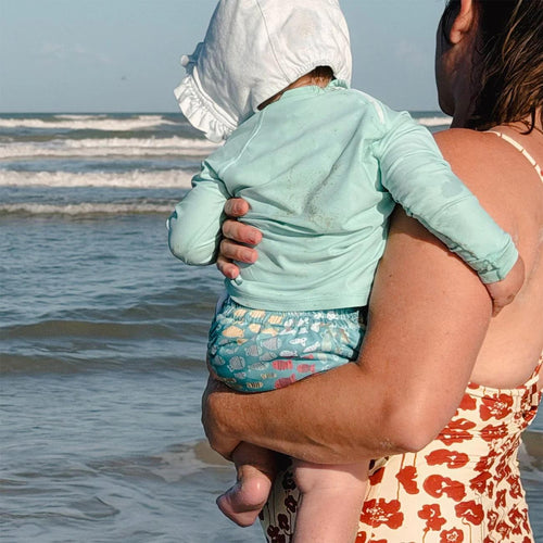 image of a baby wearing a thirsties swim diaper in schooling