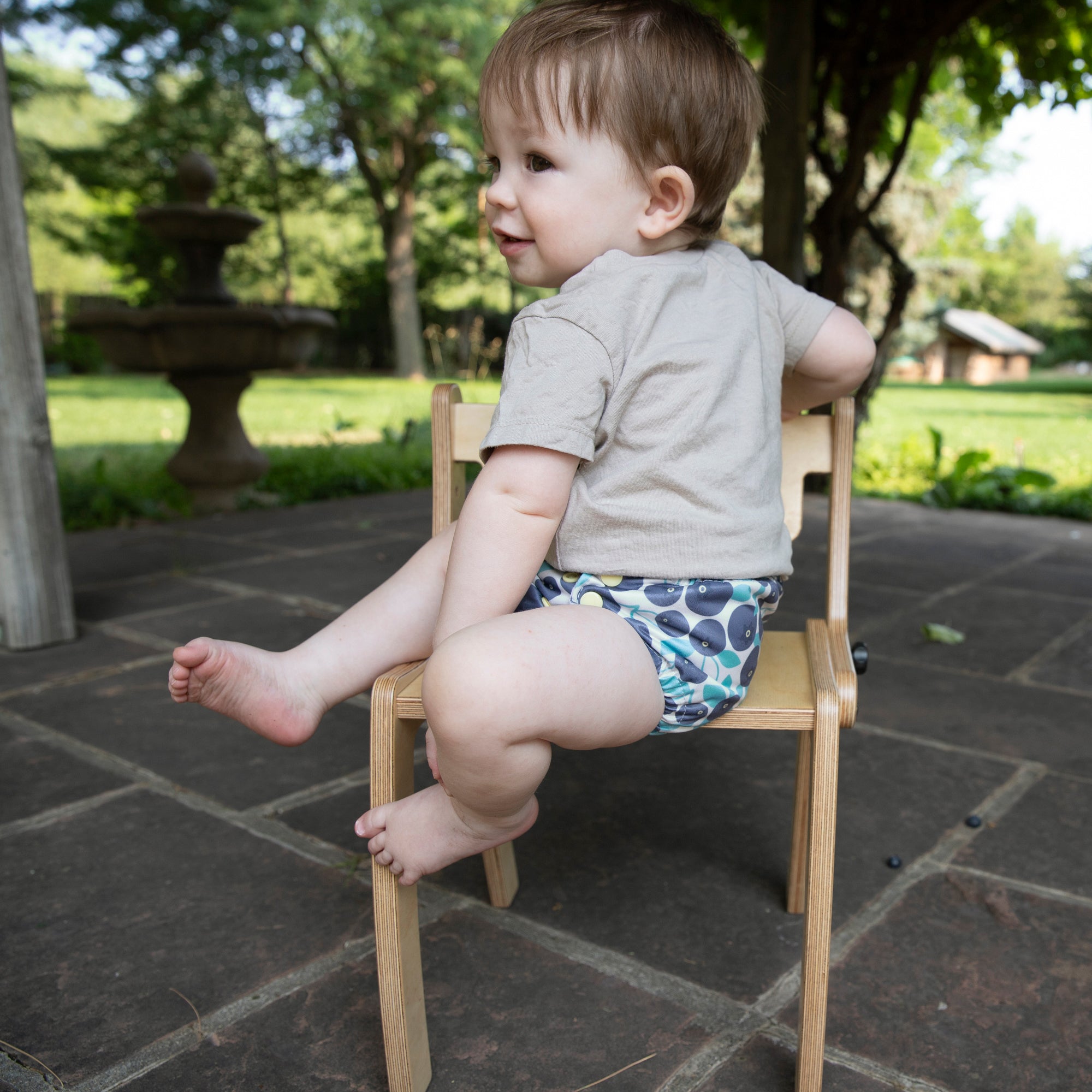 Image of baby wearing a Thirsties all in one in blueberry