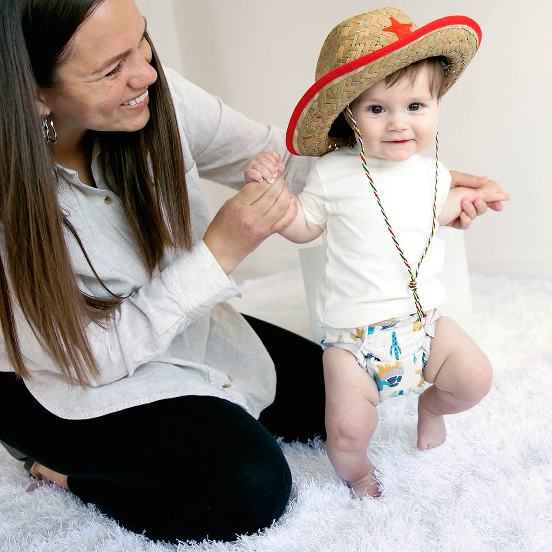 Baby wearing Thirsties All in One with snap closures in reptile wranglers