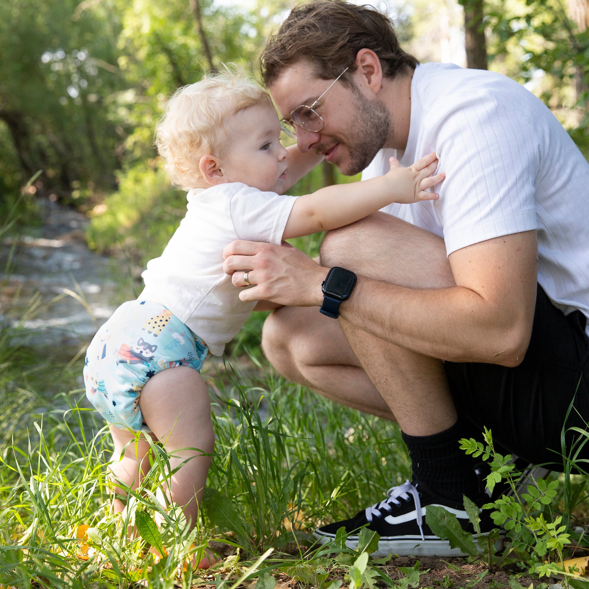 Image of Dad and baby wearing a Thirsties one size all in one cloth diaper