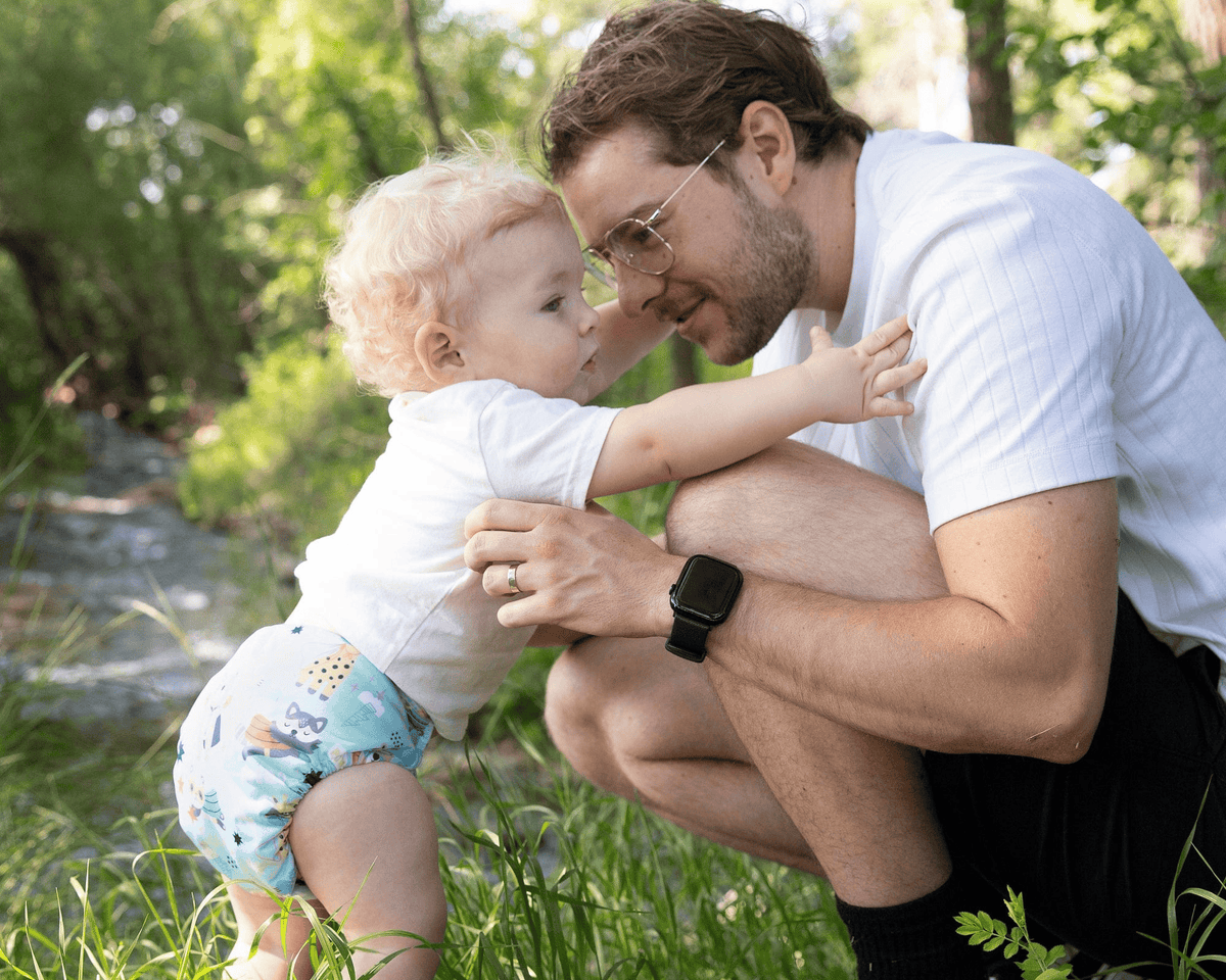 a toddler wearing a thirsties award-winning all in one baby cloth diaper in super hero print