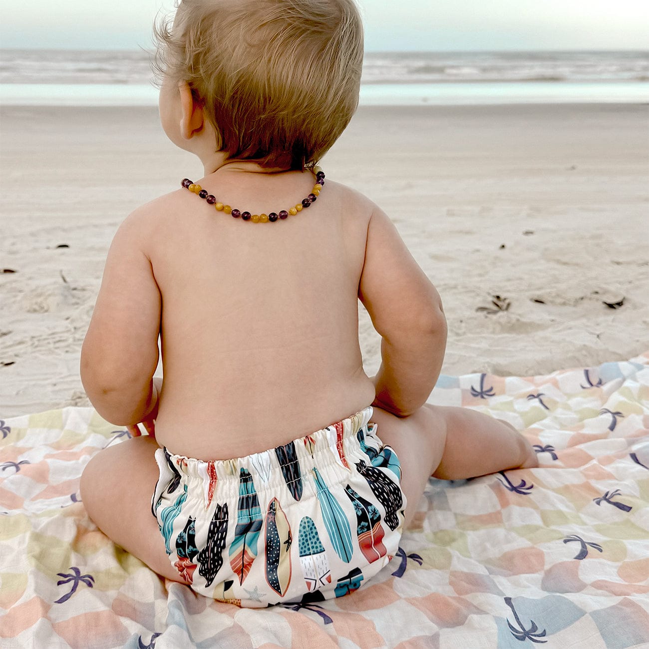 Image of baby wearing a Thirsties Swim Diaper in Cowabunga