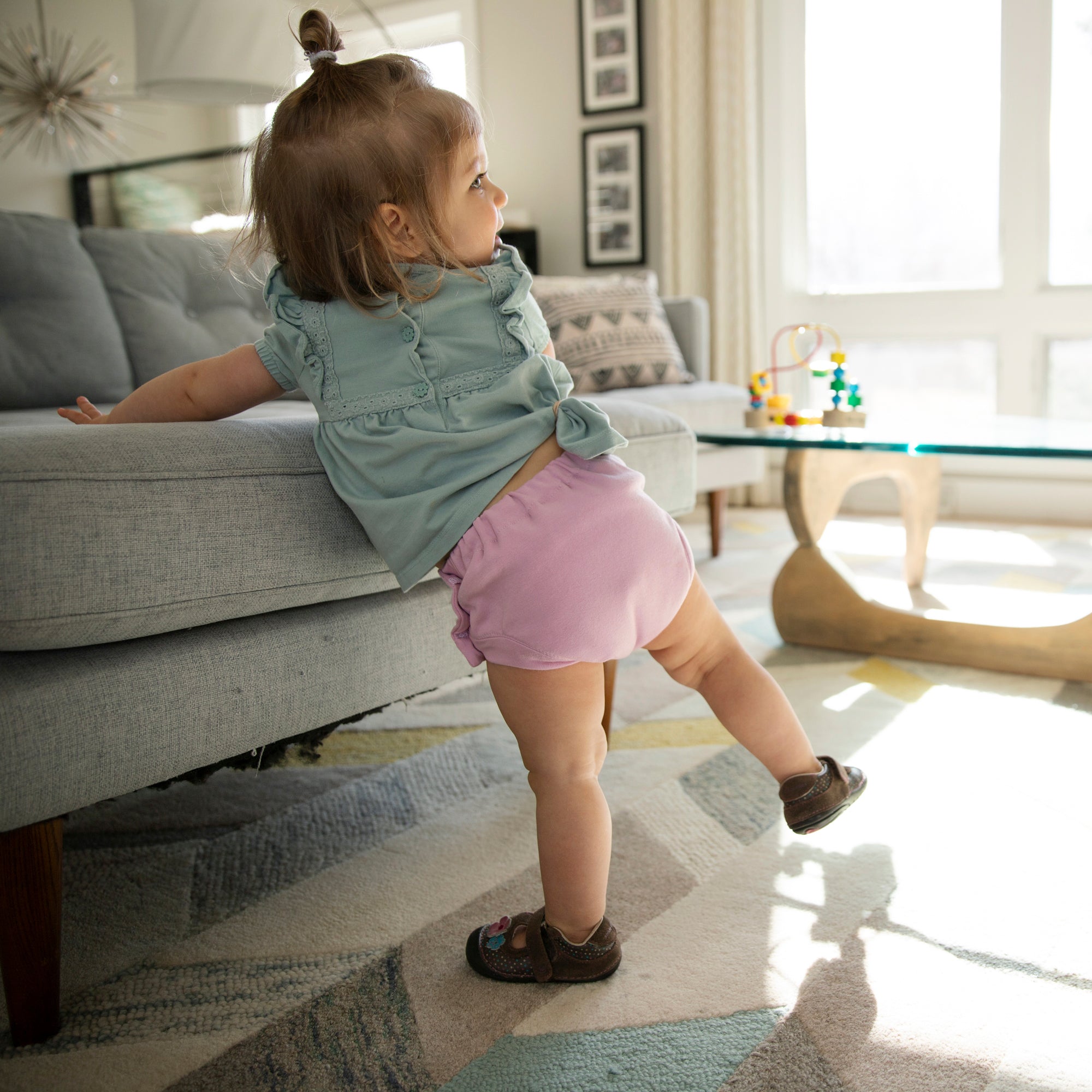 -Image of toddler wearing Thirsties resuable cloth Trainers made from organic cotton in Crocus