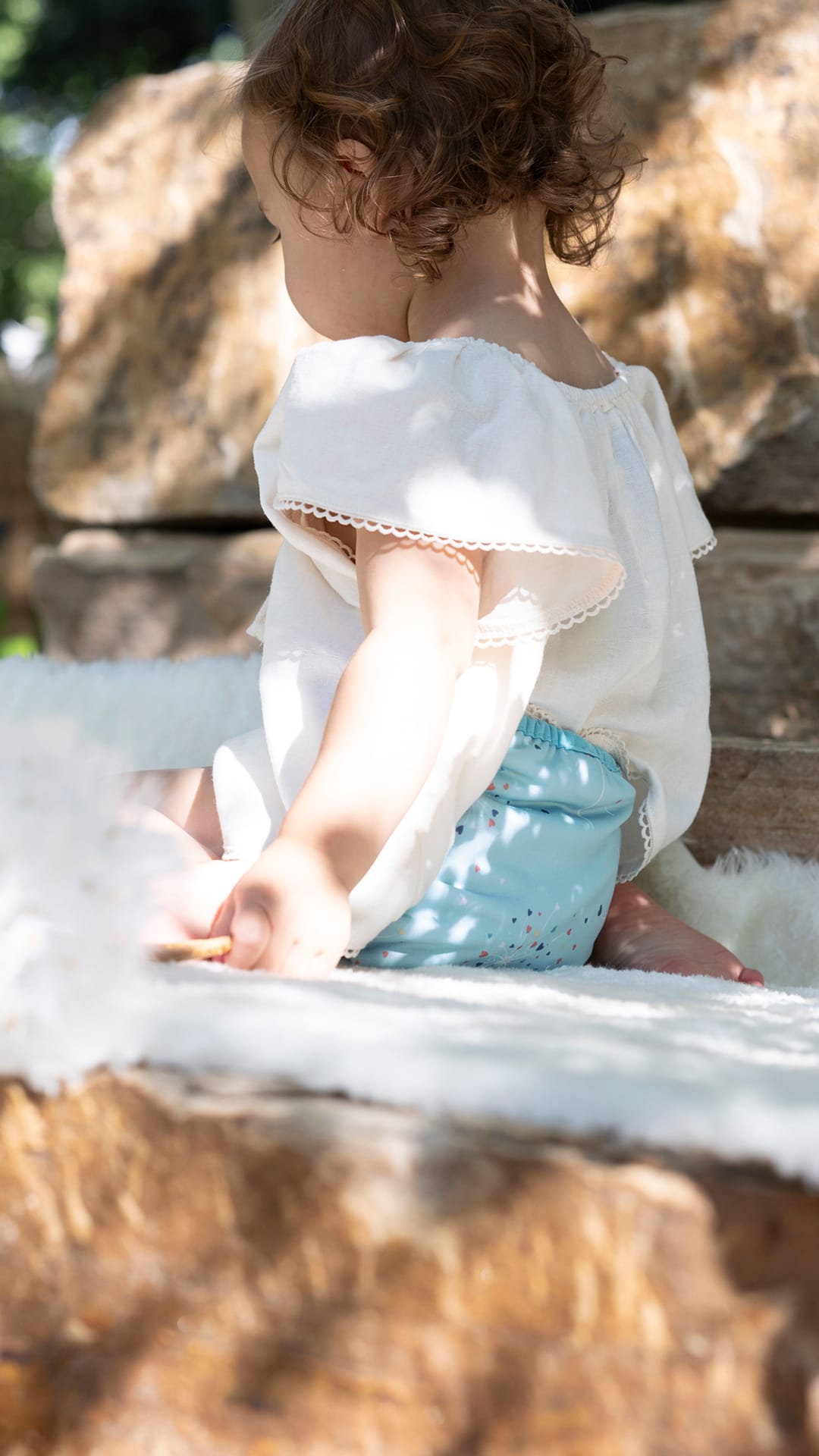 Image of toddler wearing a Thirsties Pocket Diaper in Blowing Kisses