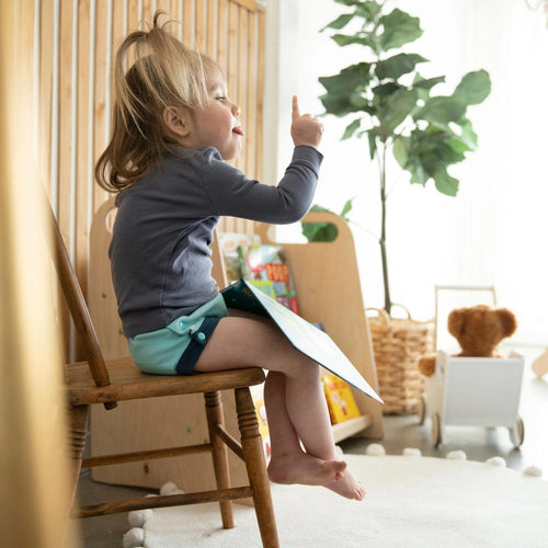 image of a toddler wearing a thirsties organic cotton trainer in lagoon