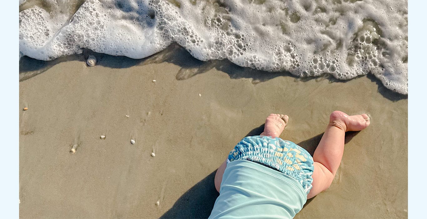 Image of baby wearing a Thirsties Swim Diaper in Schooling