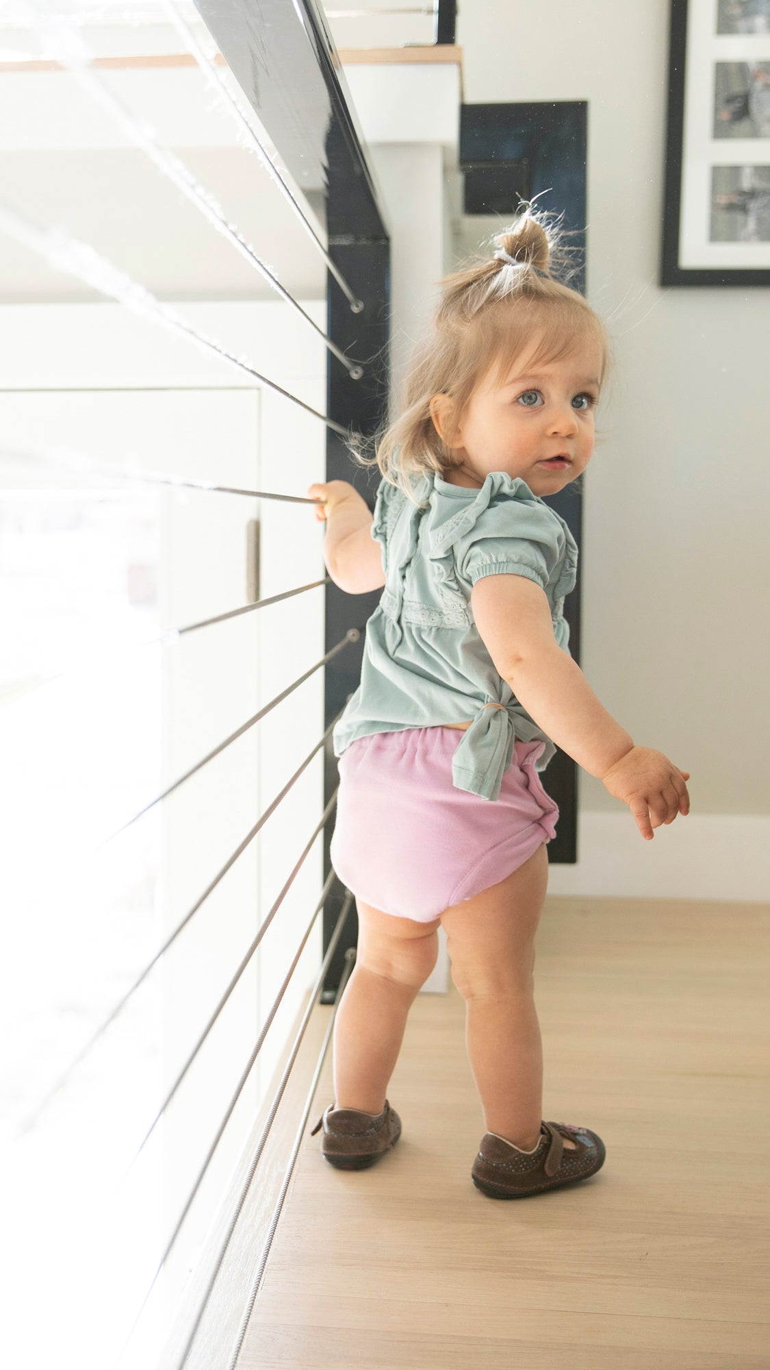 Image of Toddler wearing a Thirsties Trainer crafted from organic cotton and featuring side snap closures.