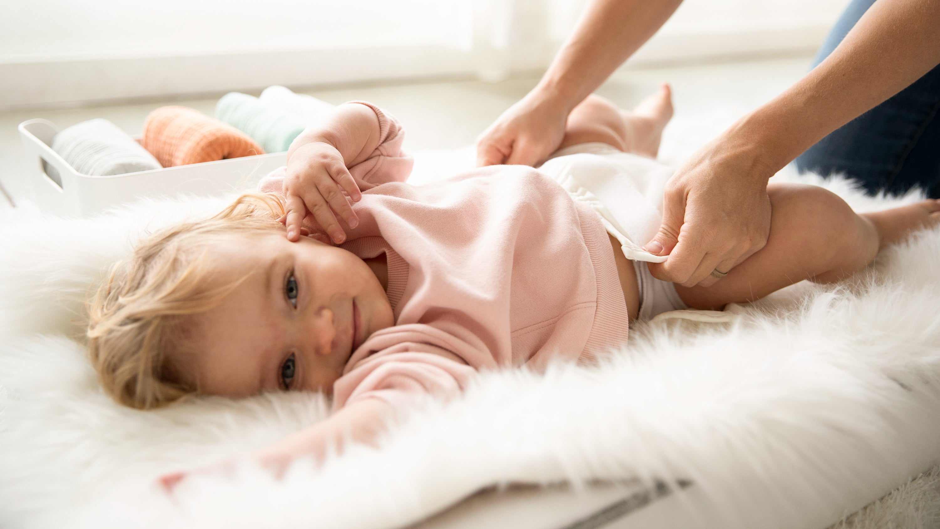 Image of a baby wearing a Thirsties Baby Cloth Diaper Cover in Birch with Hook and Loop closures