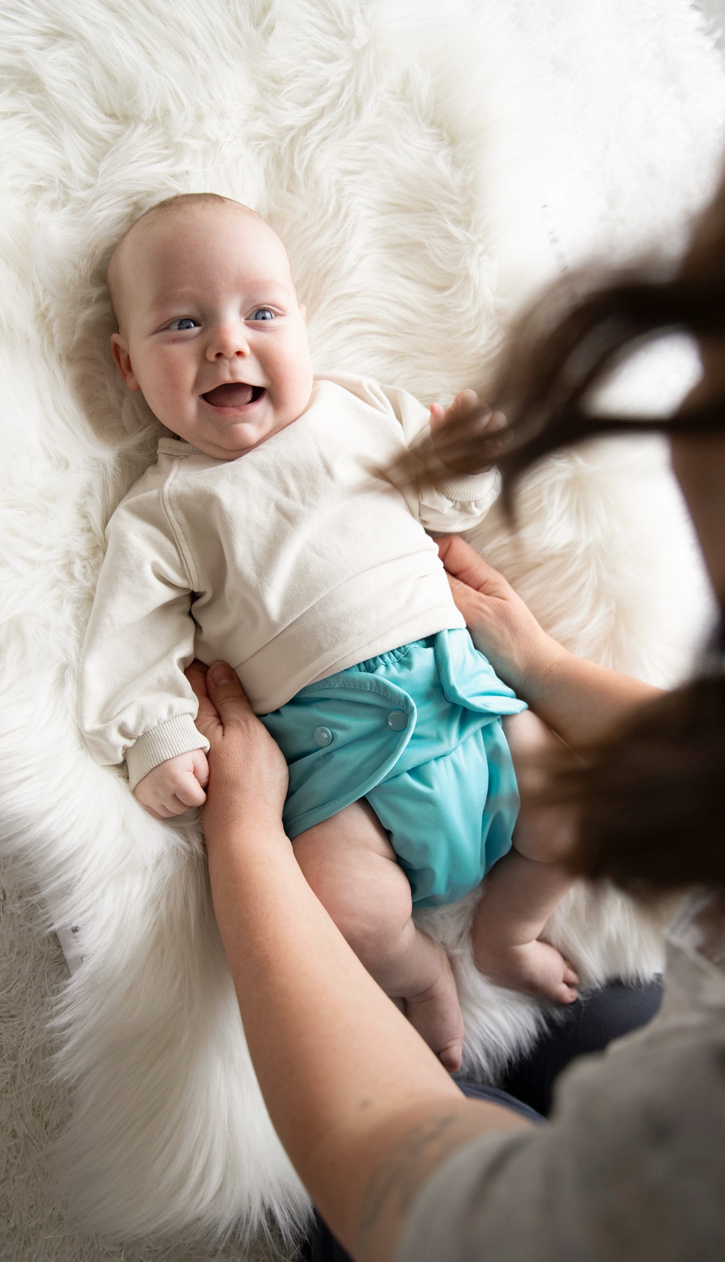 Image of baby wearing a Thirsties Duo Wrap with snap closures in Lagoon