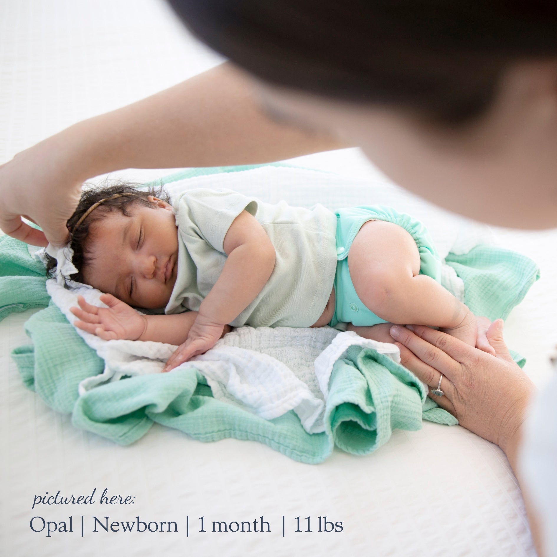 -Image of infant wearing a Thirsties Newborn All in One in Opal