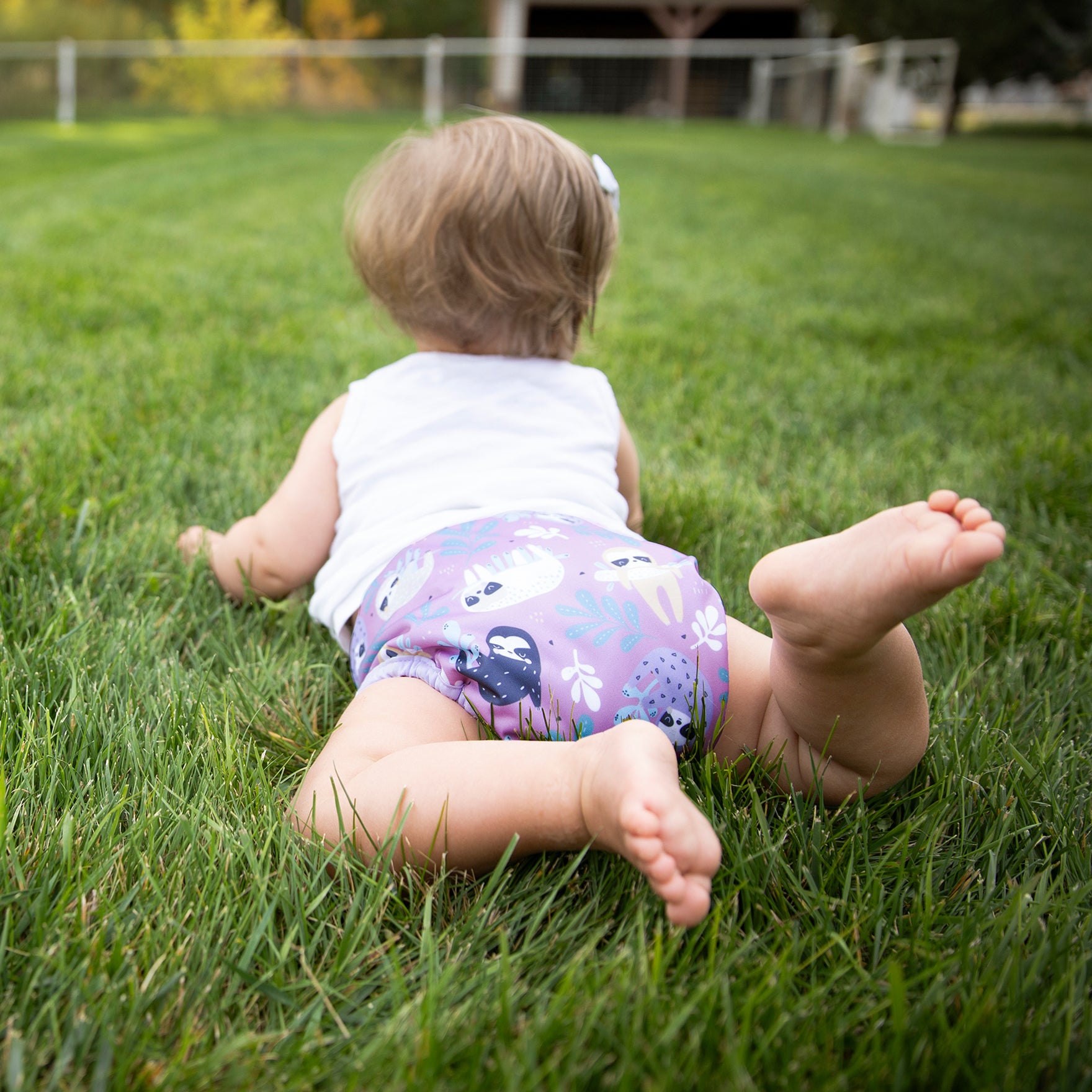 -Image of a baby wearing a Thirsties Pocket Diaper in Sloth Life Print