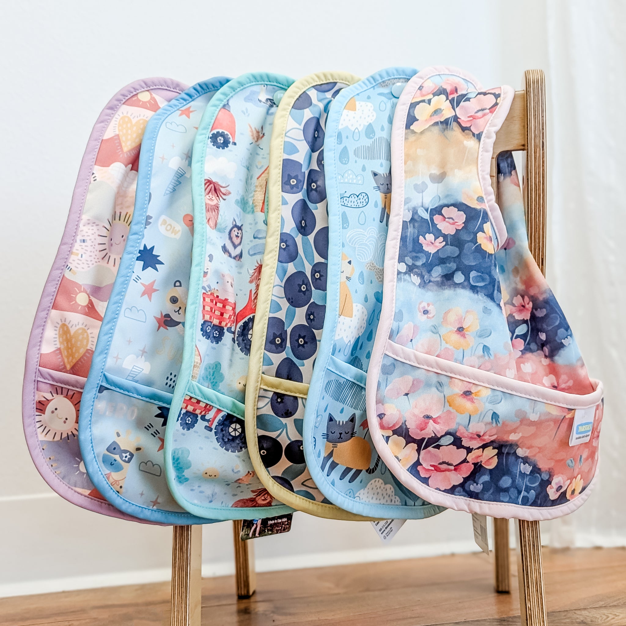 -Image of Thirsties Pocket Bibs in a colorful and delightful selection of patterns