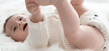 image of a baby wearing a thirsties all in one cloth diaper in bearly
