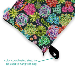 -image of thirties deluxe wet bag in desert bloom with color coordinated strap can be used to hang wet bag text